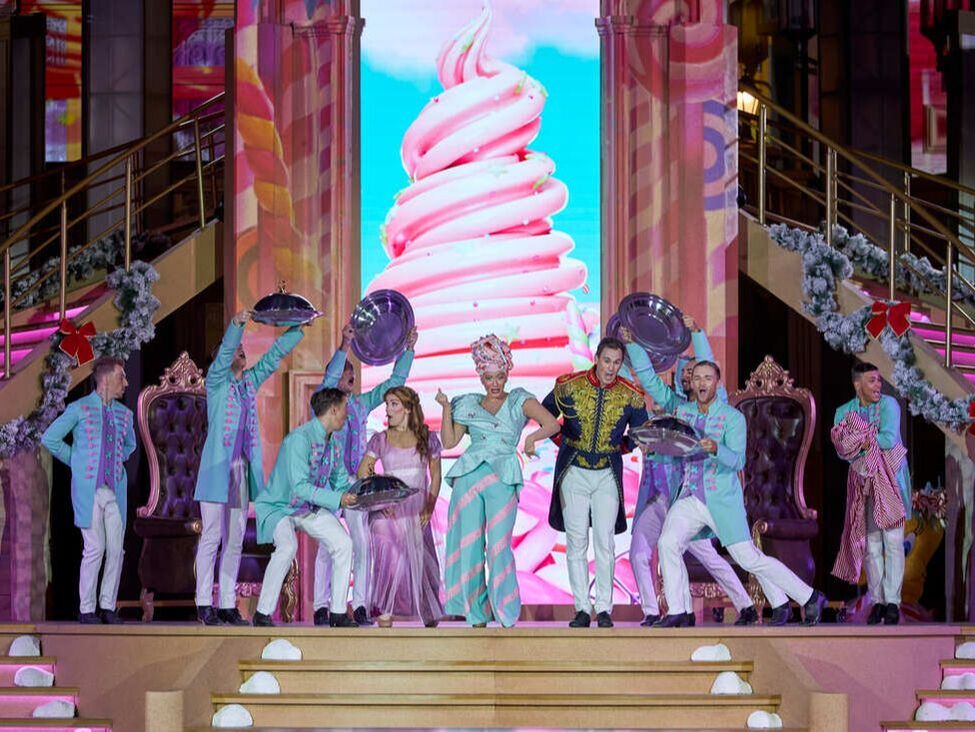 A colourful stage with musical cast